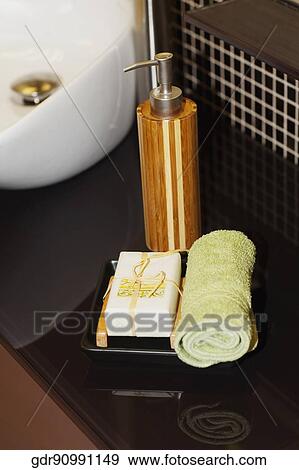 Close-up of a towel with a bar of soap and soap dispenser View Large Photo Image Stock Photo - Close-up of a towel with a bar of soap and soap dispenser. Fotosearch