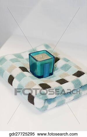 Close-up of a towel with a candle View Large Photo Image Stock Photography - Close-up of a towel with a candle. Fotosearch