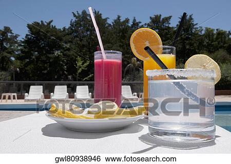 Close-up of assorted drinks at the poolside View Large Photo Image Stock Photograph - Close-up of assorted drinks at the poolside. Fotosearch