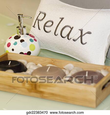 Stock Image - Close-up of candles with a soap dispenser. Fotosearch