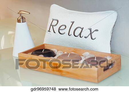 Stock Photo - Close-up of candles with a soap dispenser. Fotosearch