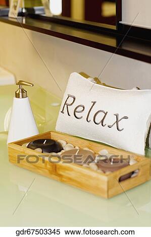 Stock Photography - Close-up of candles with a soap dispenser. Fotosearch