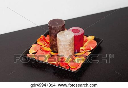 Close-up of candles with petals on a tray View Large Photo Image Picture - Close-up of candles with petals on a tray. Fotosearch