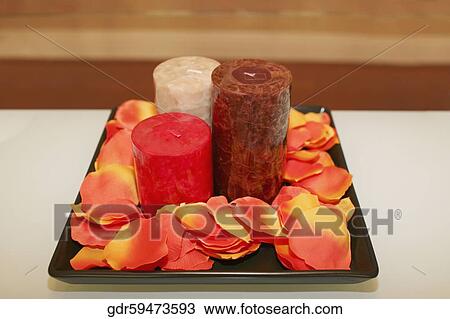 Close-up of candles with petals on a tray View Large Photo Image Stock Image - Close-up of candles with petals on a tray. Fotosearch