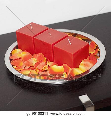 Close-up of candles with petals on a tray View Large Photo Image Stock Image - Close-up of candles with petals on a tray. Fotosearch