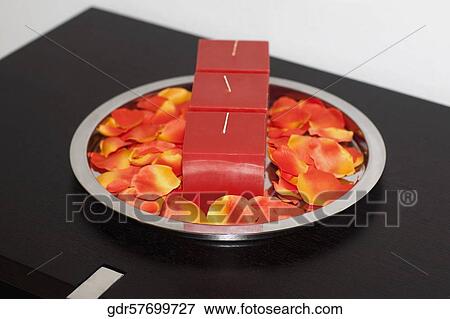 Close-up of candles with petals on a tray View Large Photo Image Stock Photo - Close-up of candles with petals on a tray. Fotosearch