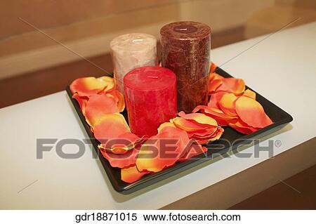 Close-up of candles with petals on a tray View Large Photo Image Stock Photography - Close-up of candles with petals on a tray. Fotosearch