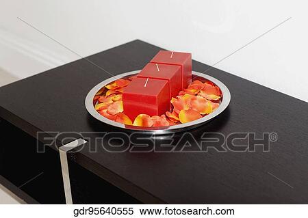 Close-up of candles with petals on a tray View Large Photo Image Stock Photography - Close-up of candles with petals on a tray. Fotosearch