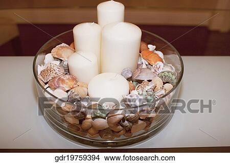 Close-up of candles with shells in a glass bowl View Large Photo Image Picture - Close-up of candles with shells in a glass bowl. Fotosearch