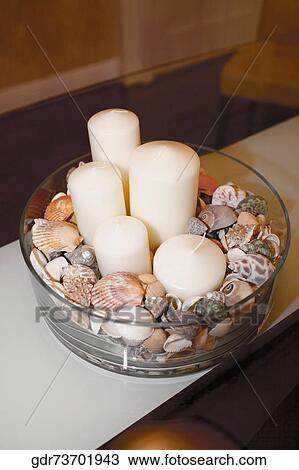 Close-up of candles with shells in a glass bowl View Large Photo Image Stock Image - Close-up of candles with shells in a glass bowl. Fotosearch
