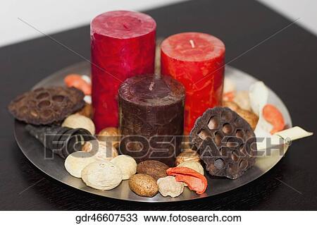 Stock Image - Close-up of candles with shells on a tray. Fotosearch