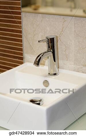 Close-up of faucet on a bathroom sink View Large Photo Image Picture - Close-up of faucet on a bathroom sink. Fotosearch
