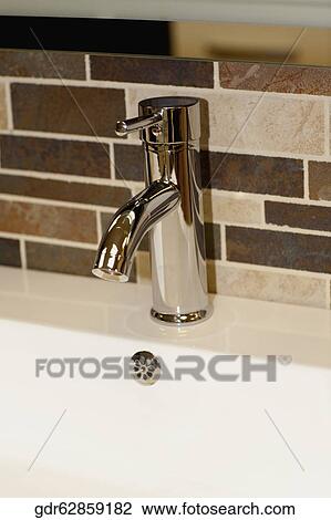 Close-up of faucet on a bathroom sink View Large Photo Image Stock Image - Close-up of faucet on a bathroom sink. Fotosearch