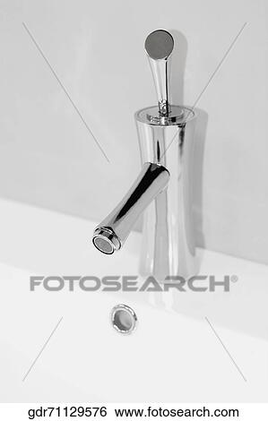 Close-up of faucet on a bathroom sink View Large Photo Image Stock Photograph - Close-up of faucet on a bathroom sink. Fotosearch