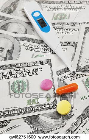 Close-up of hundred dollar bills with pills and a thermometer View Large Photo Image Stock Image - Close-up of hundred dollar bills with pills and a thermometer. Fotosearch
