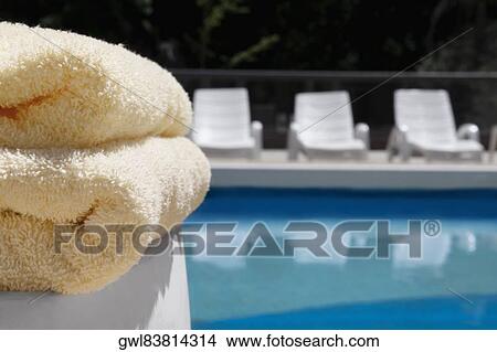 Close-up of towels and lounge chairs at the poolside View Large Photo Image Picture - Close-up of towels and lounge chairs at the poolside. Fotosearch