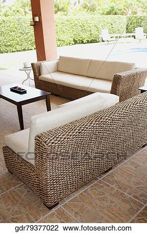 Stock Image - Couch in the porch. Fotosearch