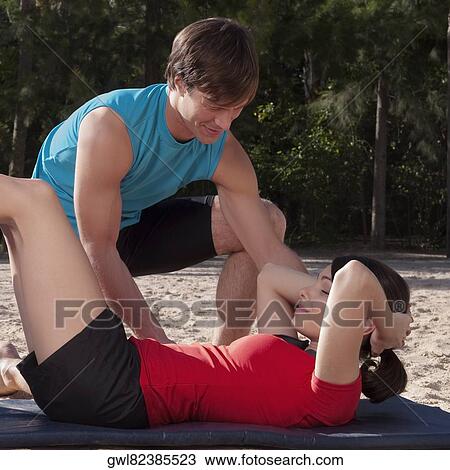 Couple exercising on the beach View Large Photo Image Stock Image - Couple exercising on the beach. Fotosearch