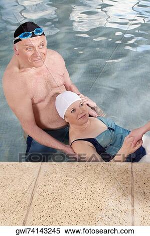 Couple in a swimming pool View Large Photo Image Stock Photography - Couple in a swimming pool. Fotosearch