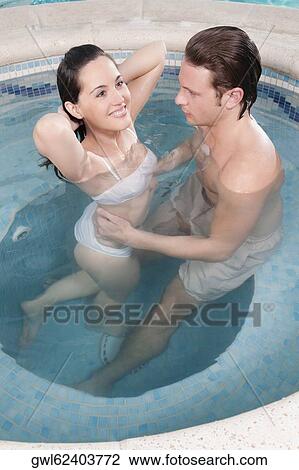 Couple romancing in a hot tub View Large Photo Image Stock Image - Couple romancing in a hot tub. Fotosearch