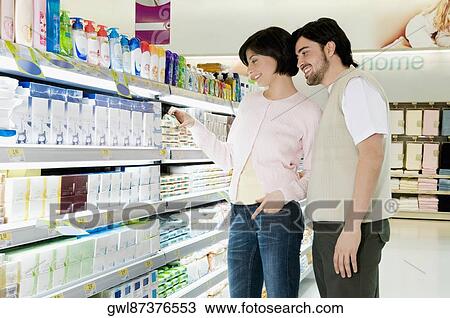 Couple shopping in a supermarket View Large Photo Image Stock Image - Couple shopping in a supermarket. Fotosearch