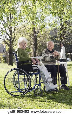 Couple sitting in a park View Large Photo Image Stock Image - Couple sitting in a park. Fotosearch