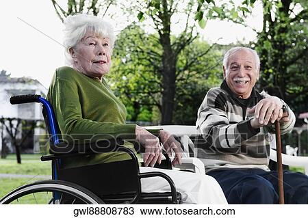 Couple sitting in a park View Large Photo Image Stock Image - Couple sitting in a park. Fotosearch