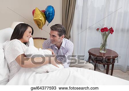 Couple with their newborn baby in a hospital View Large Photo Image Stock Image - Couple with their newborn baby in a hospital. Fotosearch