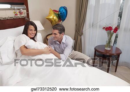 Couple with their newborn baby in a hospital View Large Photo Image Stock Image - Couple with their newborn baby in a hospital. Fotosearch