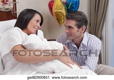Couple with their newborn baby in a hospital View Large Photo Image Stock Image - Couple with their newborn baby in a hospital. Fotosearch