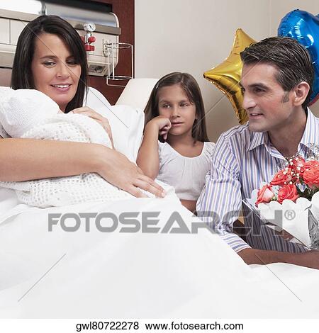 Couple with their newborn baby in a hospital View Large Photo Image Stock Photo - Couple with their newborn baby in a hospital. Fotosearch