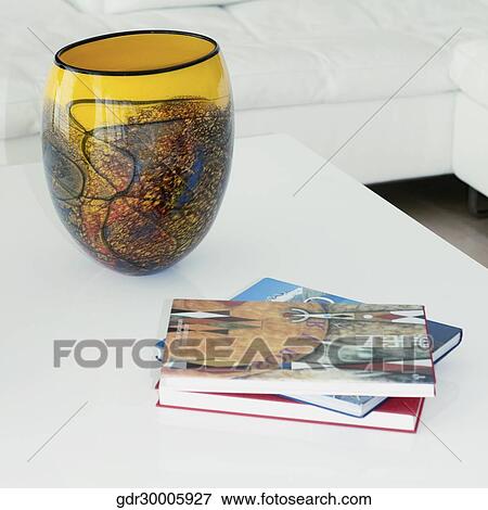 Decorative urn and magazines on a table View Large Photo Image Stock Photo - Decorative urn and magazines on a table. Fotosearch