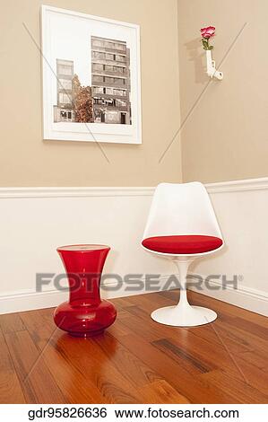 Decorative urn next to a chair in the corner of a room View Large Photo Image Stock Photograph - Decorative urn next to a chair in the corner of a room. Fotosearch