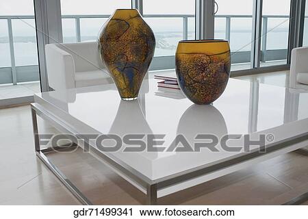 Decorative urns and magazines on a table View Large Photo Image Stock Image - Decorative urns and magazines on a table. Fotosearch