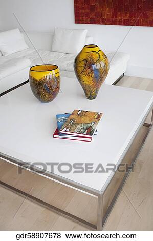 Stock Photo - Decorative urns and magazines on a table. Fotosearch