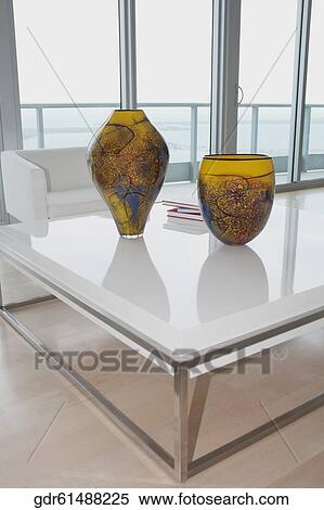 Decorative urns and magazines on a table View Large Photo Image Stock Photography - Decorative urns and magazines on a table. Fotosearch