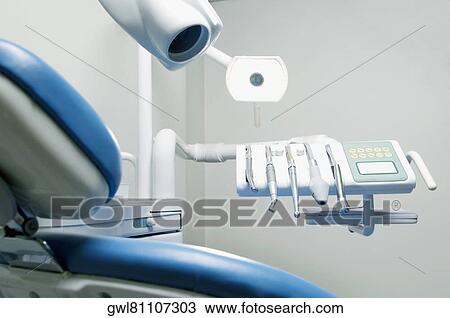 Dentist's chair with dental equipments in an examination room View Large Photo Image Stock Image - Dentist's chair with dental equipments in an examination room. Fotosearch