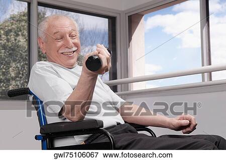 Disabled man exercising with dumbbells and smiling View Large Photo Image Stock Photo - Disabled man exercising with dumbbells and smiling. Fotosearch
