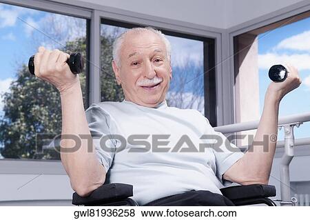 Stock Photo - Disabled man exercising with dumbbells. Fotosearch