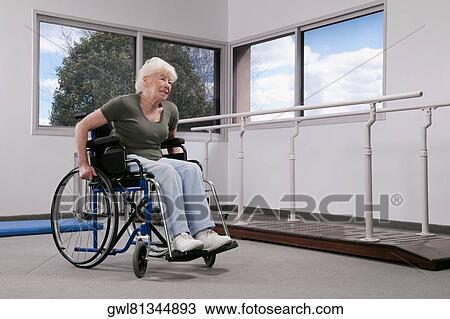 Disabled woman sitting in a wheelchair View Large Photo Image Stock Image - Disabled woman sitting in a wheelchair. Fotosearch