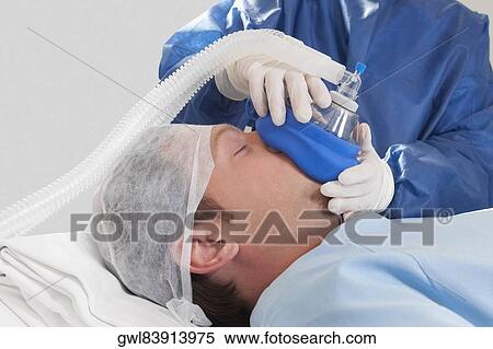 Doctor anaesthetizing a patient in an operating room View Large Photo Image Stock Photography - Doctor anaesthetizing a patient in an operating room. Fotosearch