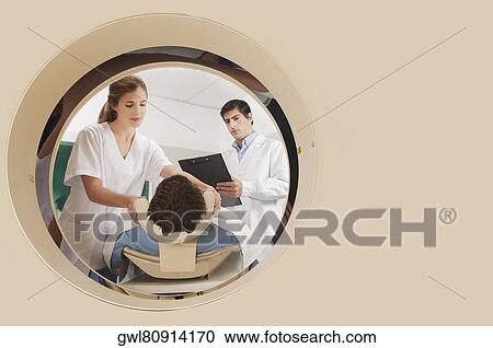 Doctor and nurse preparing a patient for MRI scan View Large Photo Image Stock Image - Doctor and nurse preparing a patient for MRI scan. Fotosearch