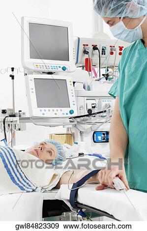 Doctor attaching pulse oxymeter to a patient's finger View Large Photo Image Stock Photo - Doctor attaching pulse oxymeter to a patient's finger. Fotosearch