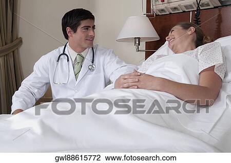 Doctor discussing with a patient View Large Photo Image Stock Image - Doctor discussing with a patient. Fotosearch