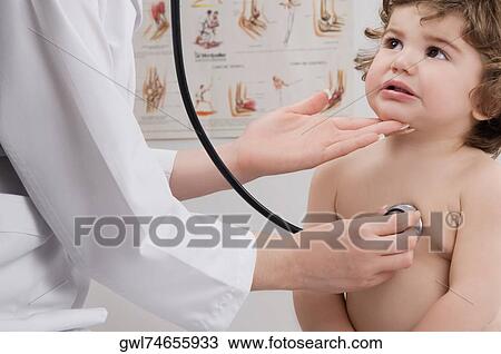 Doctor examining a baby boy with a stethoscope View Large Photo Image Stock Image - Doctor examining a baby boy with a stethoscope. Fotosearch