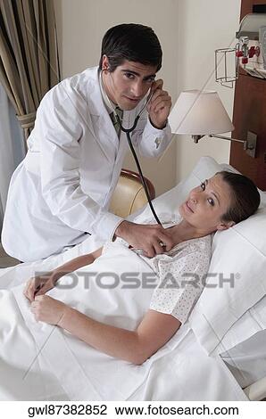 Doctor examining a woman View Large Photo Image Stock Image - Doctor examining a woman. Fotosearch