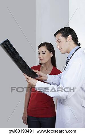 Doctor explaining x-ray report to a patient View Large Photo Image Stock Image - Doctor explaining x-ray report to a patient. Fotosearch