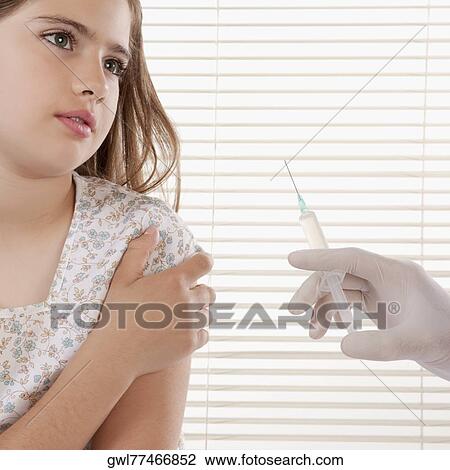 Doctor giving an injecting to a girl View Large Photo Image Stock Image - Doctor giving an injecting to a girl. Fotosearch