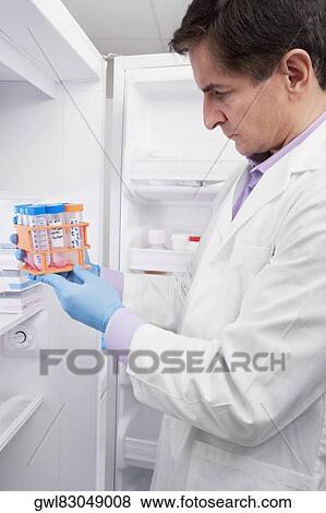 Doctor holding medical samples in a laboratory View Large Photo Image Stock Photo - Doctor holding medical samples in a laboratory. Fotosearch