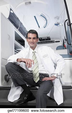 Doctor sitting in an ambulance and smiling View Large Photo Image Stock Image - Doctor sitting in an ambulance and smiling. Fotosearch